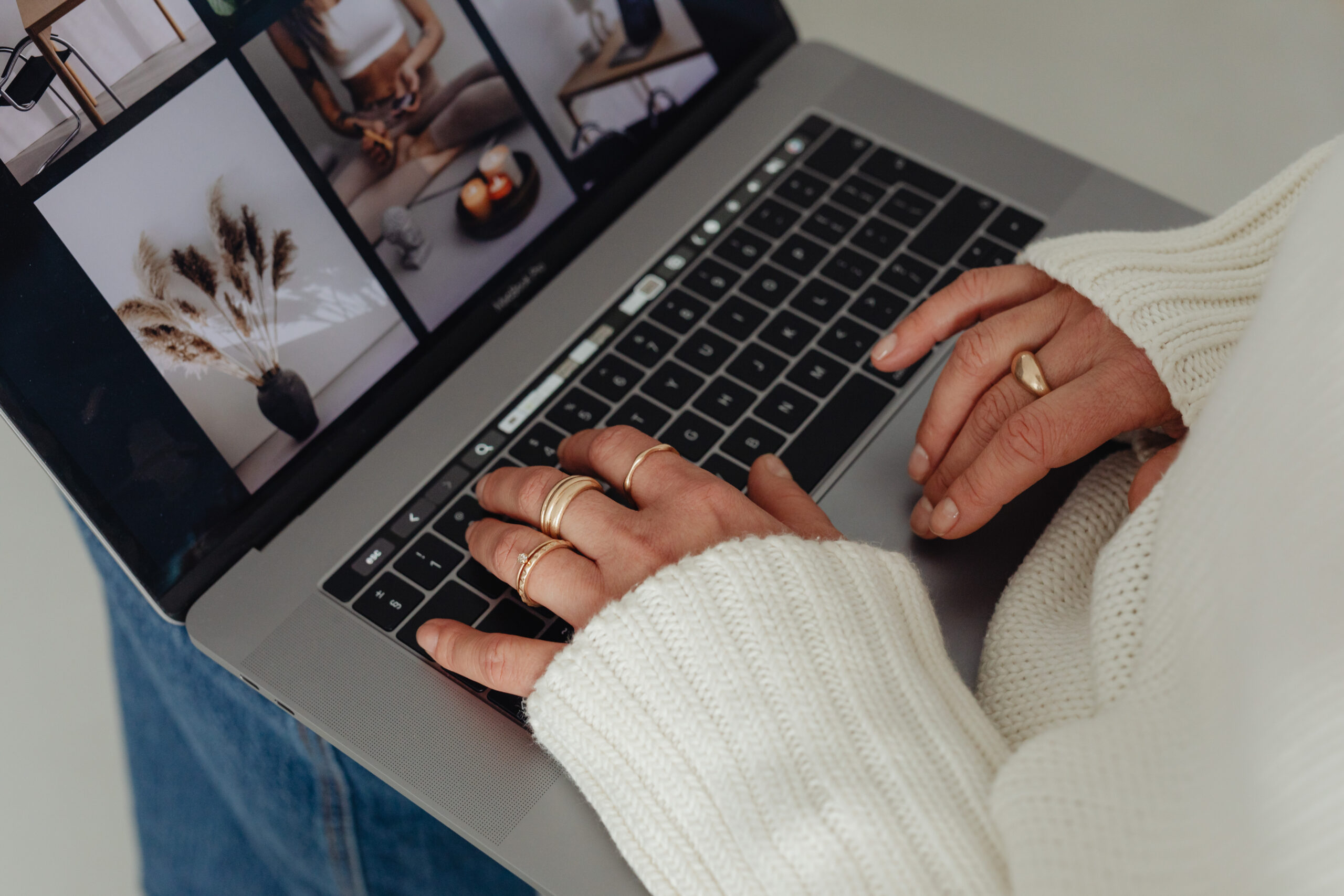 Woman on laptop sorting through photos for Pinterest.